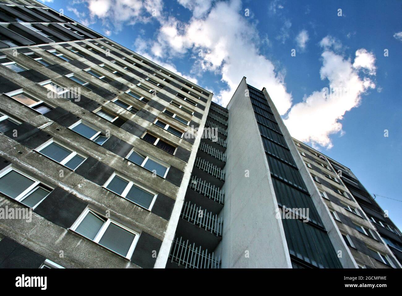 Block of flats with blue sky and clouds, urban building, real estate