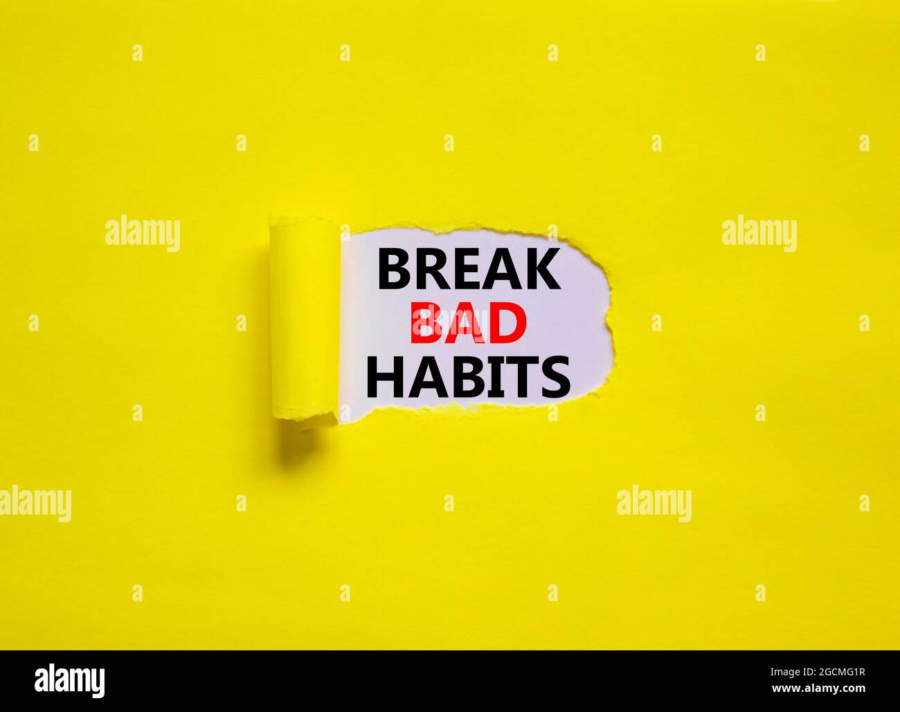 Break bad habits symbol. Words 'Break bad habits' appearing behind torn
