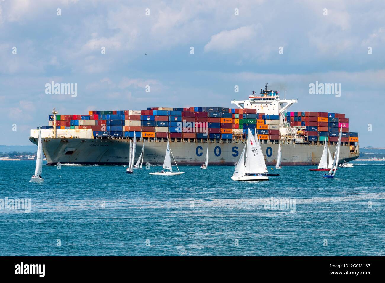 cowes week, container ship in solent, container ship close to yachts, container ship in thorn channel, container ship arriving in solent  southampton. Stock Photo