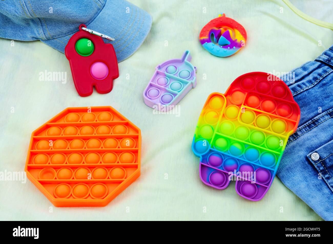Colorful antistress sensory toys fidget push Pop it, Simple Dimple, and  Snapperz. Trend games. Happy childhood concept Stock Photo - Alamy