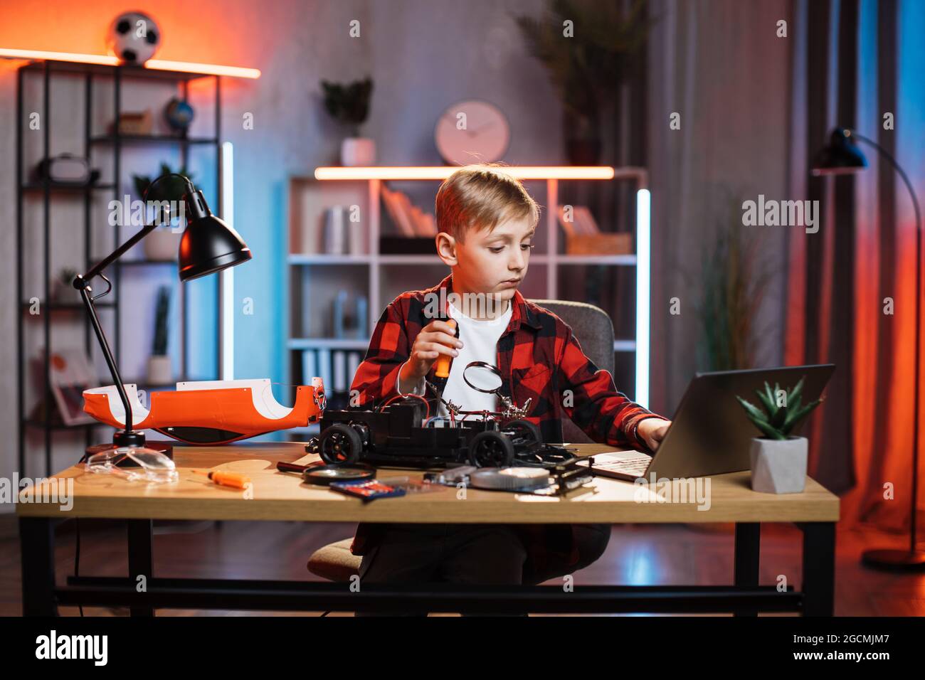 Little Boy Playing Car Game On Computer At Home Stock Photo