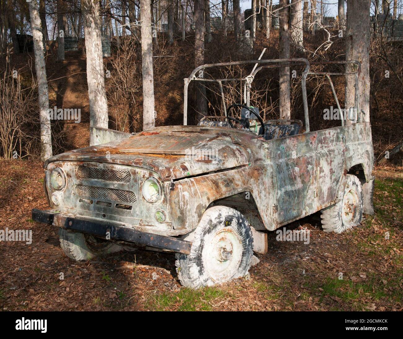 Damaged car used on paintball area Stock Photo