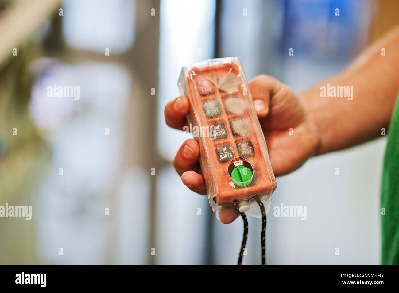 Technician show shutdown button on control panel in power plant. Stock Photo