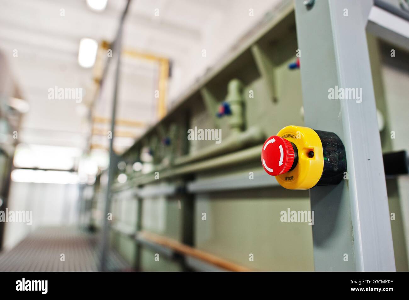 Red emergency button or stop button for industrial machine, emergency stop for safety. Stock Photo