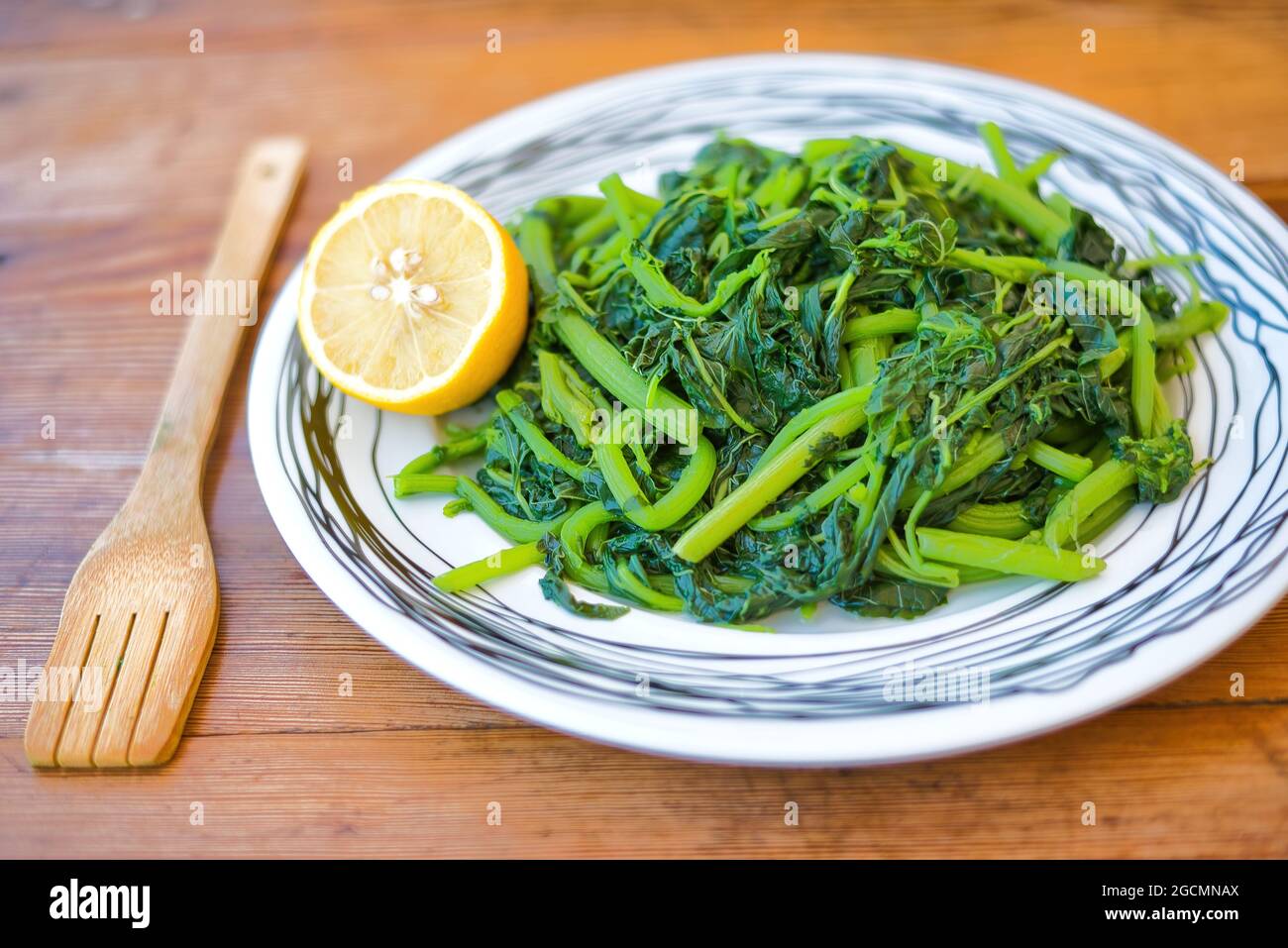 Amaranthus blitum . Vlita Salad on a plate, on a wooden old table Stock Photo