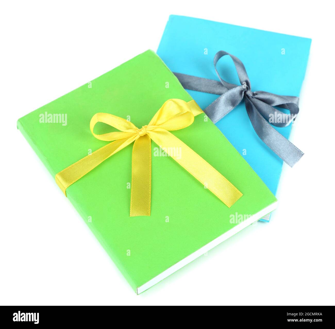 Books wrapped with color ribbons, isolated on white Stock Photo Alamy