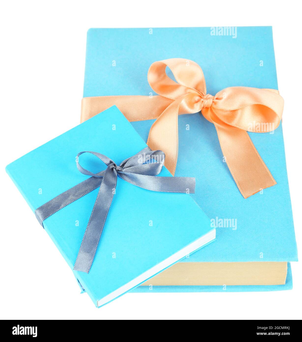 Books wrapped with color ribbons, isolated on white Stock Photo Alamy