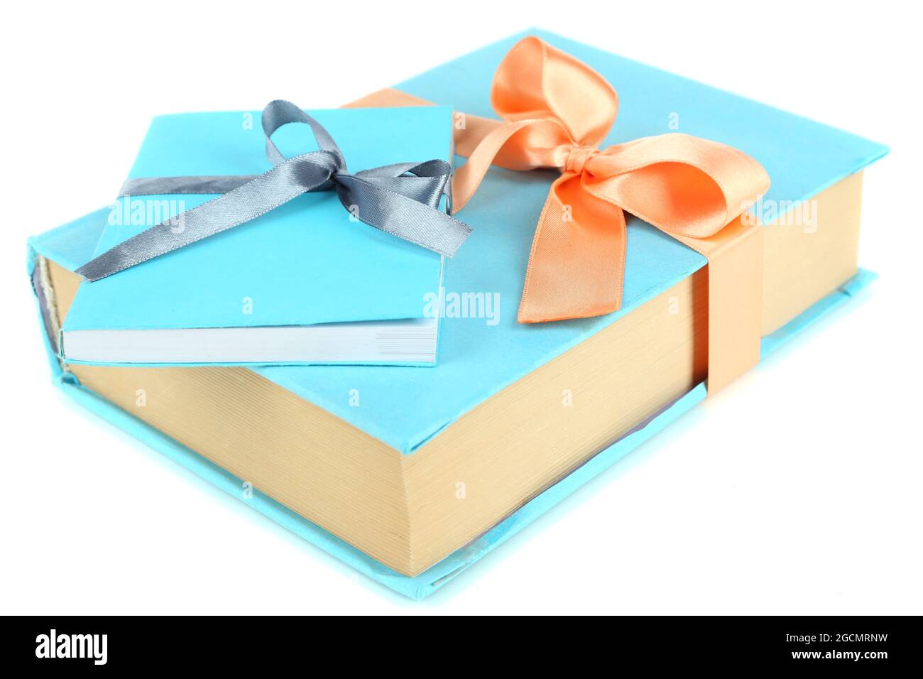 Books wrapped with color ribbons, isolated on white Stock Photo Alamy