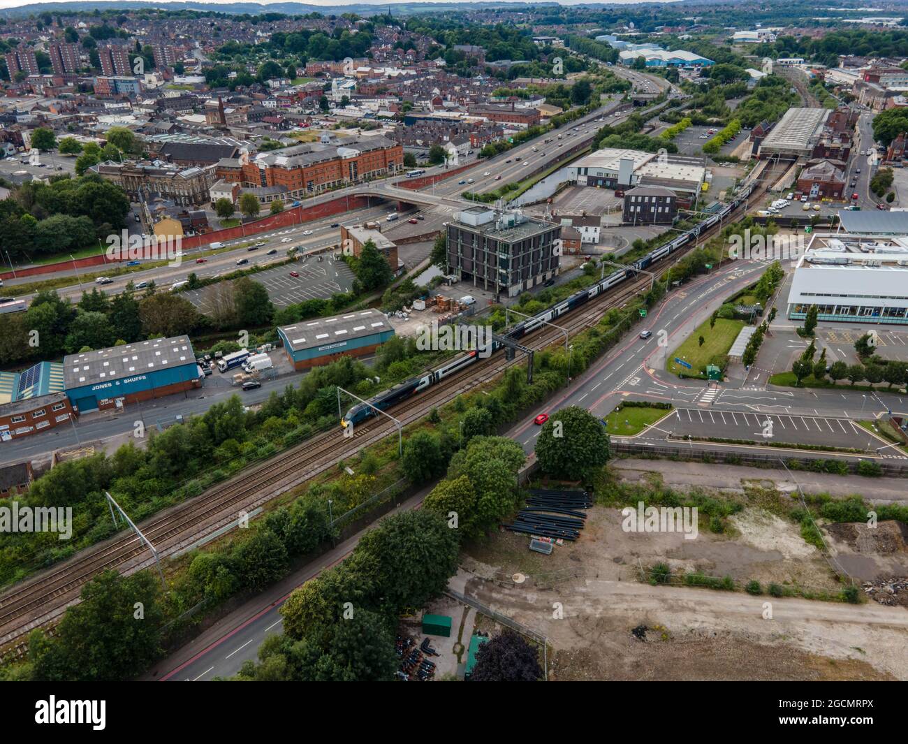 Train Approaching Stoke on Trent Railway Station aerial drone view intercity pendaleno train Stock Photo