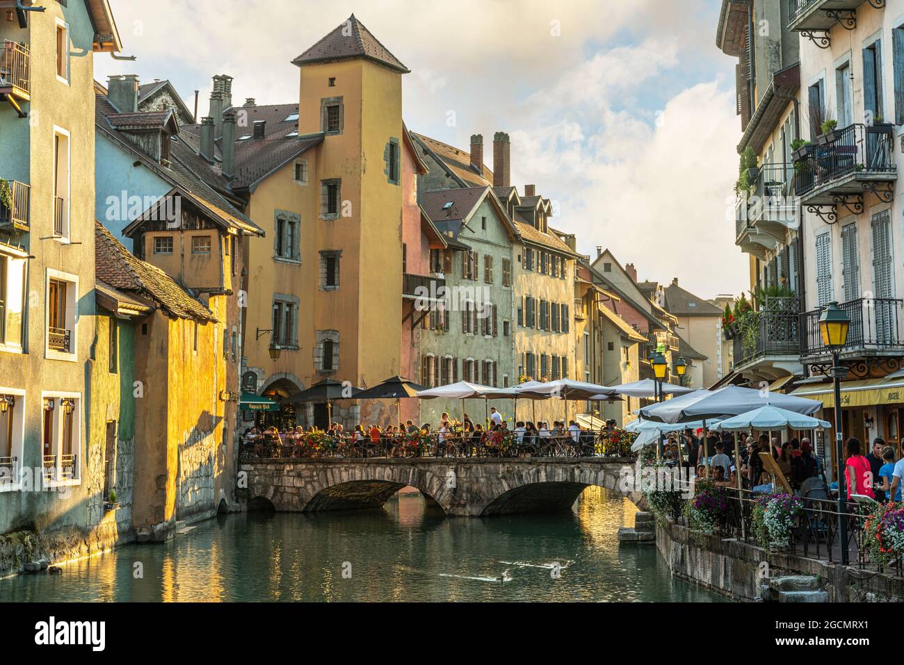 Tourists strolling through the streets of the ancient city of Annecy. The bridges connect the two banks of the Thiou River. Annecy, France Stock Photo