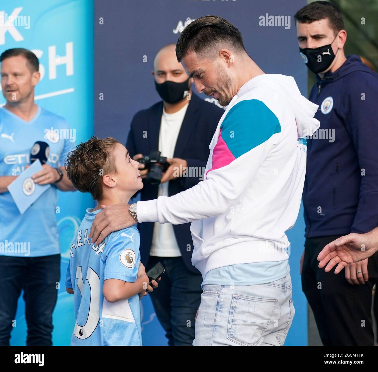 Manchester, UK. 9th Aug, 2021. Jack Grealish meets a young fan wearing his shirt who broke through the barriers as Manchester City publicly unveil their new signing at the Etihad Stadium, Manchester. Picture date: 9th August 2021. Picture credit should read: Andrew Yates/Sportimage Credit: Sportimage/Alamy Live News Stock Photo