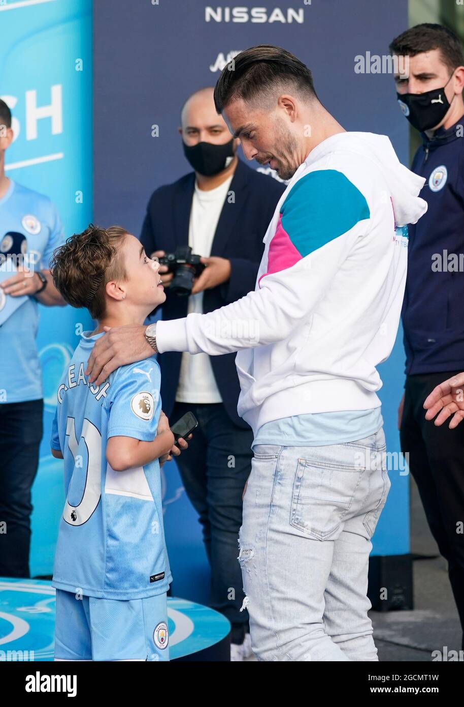 Manchester, UK. 9th Aug, 2021. Jack Grealish meets a young fan wearing his shirt who broke through the barriers as Manchester City publicly unveil their new signing at the Etihad Stadium, Manchester. Picture date: 9th August 2021. Picture credit should read: Andrew Yates/Sportimage Credit: Sportimage/Alamy Live News Stock Photo