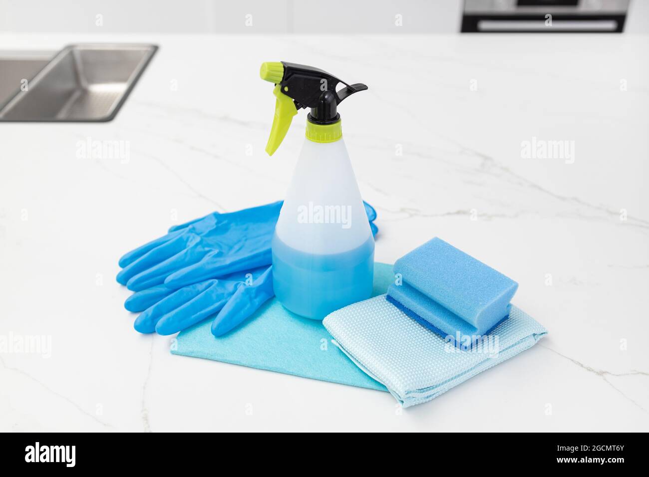 Cleaning supplies on modern kitchen. House cleaning concept. Copy space