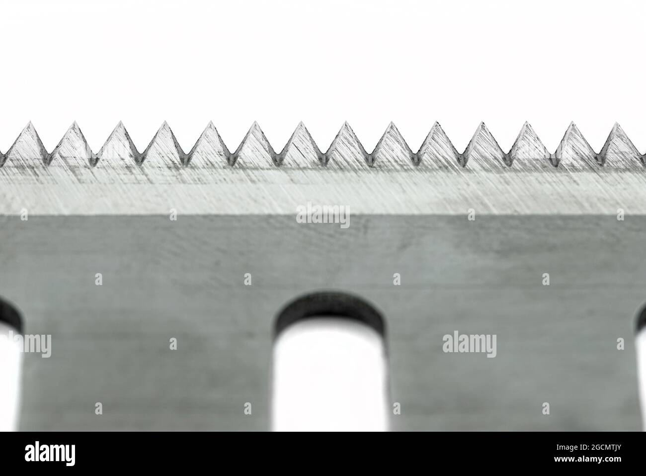 A macro photo of a serrated industrial blade for tape cutters, isolated