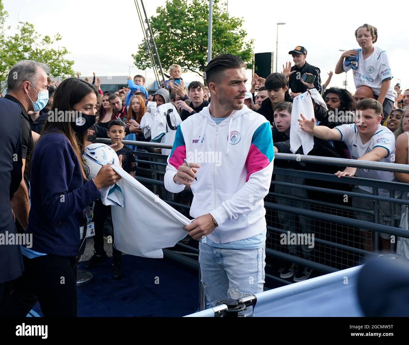 Manchester, UK. 9th Aug, 2021. Jack Grealish signs a shirt for the fans as Manchester City publicly unveil their new signing at the Etihad Stadium, Manchester. Picture date: 9th August 2021. Picture credit should read: Andrew Yates/Sportimage Credit: Sportimage/Alamy Live News Stock Photo