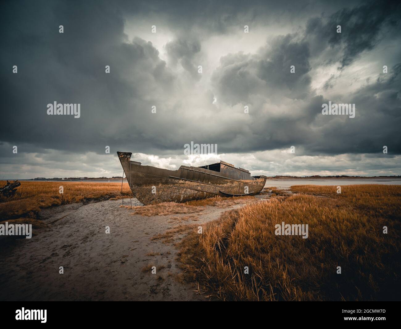 old rotting hull of abandoned fishing boat beached on the mud at low tide Fleetwood Stock Photo
