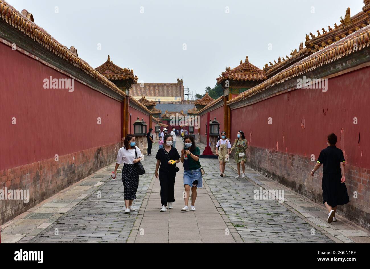 Beijing, China. 8th Aug, 2021. People wearing face masks as a preventive measure against the spread of covid-19 walk around the Forbidden City in Beijing.President Xi Jinping said on Thursday that China will provide a total of 2 billion doses of COVID-19 vaccines to the world this year, in the latest effort to honor its commitment to make vaccines a global public good by ensuring vaccine accessibility and affordability. (Credit Image: © Sheldon Cooper/SOPA Images via ZUMA Press Wire) Stock Photo