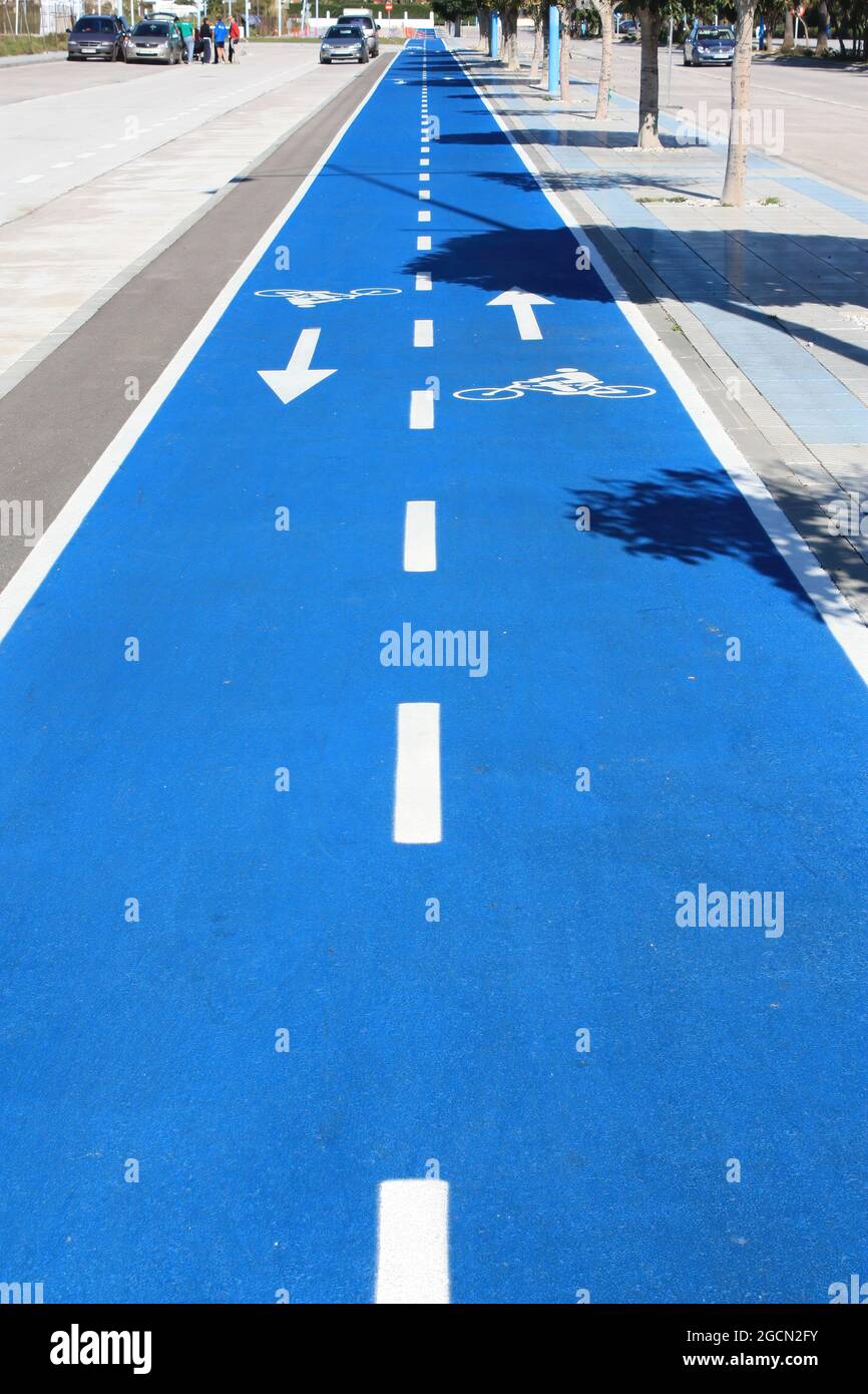 Marbella, Spain-March 20, 2021.Blue bike path near the beach and the sea in Marbella. Stock Photo
