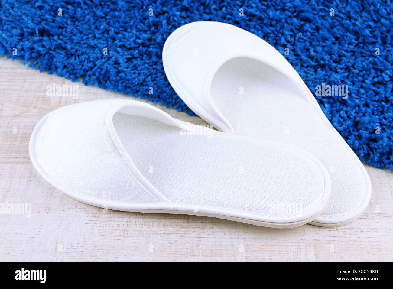 White slippers on floor background Stock Photo - Alamy