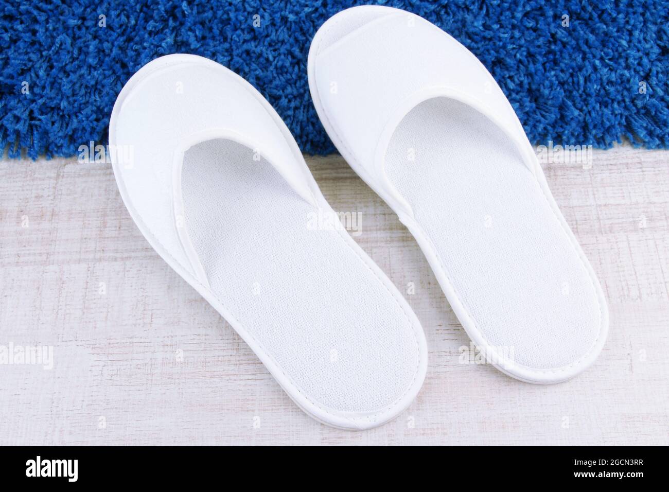 White slippers on floor background Stock Photo - Alamy