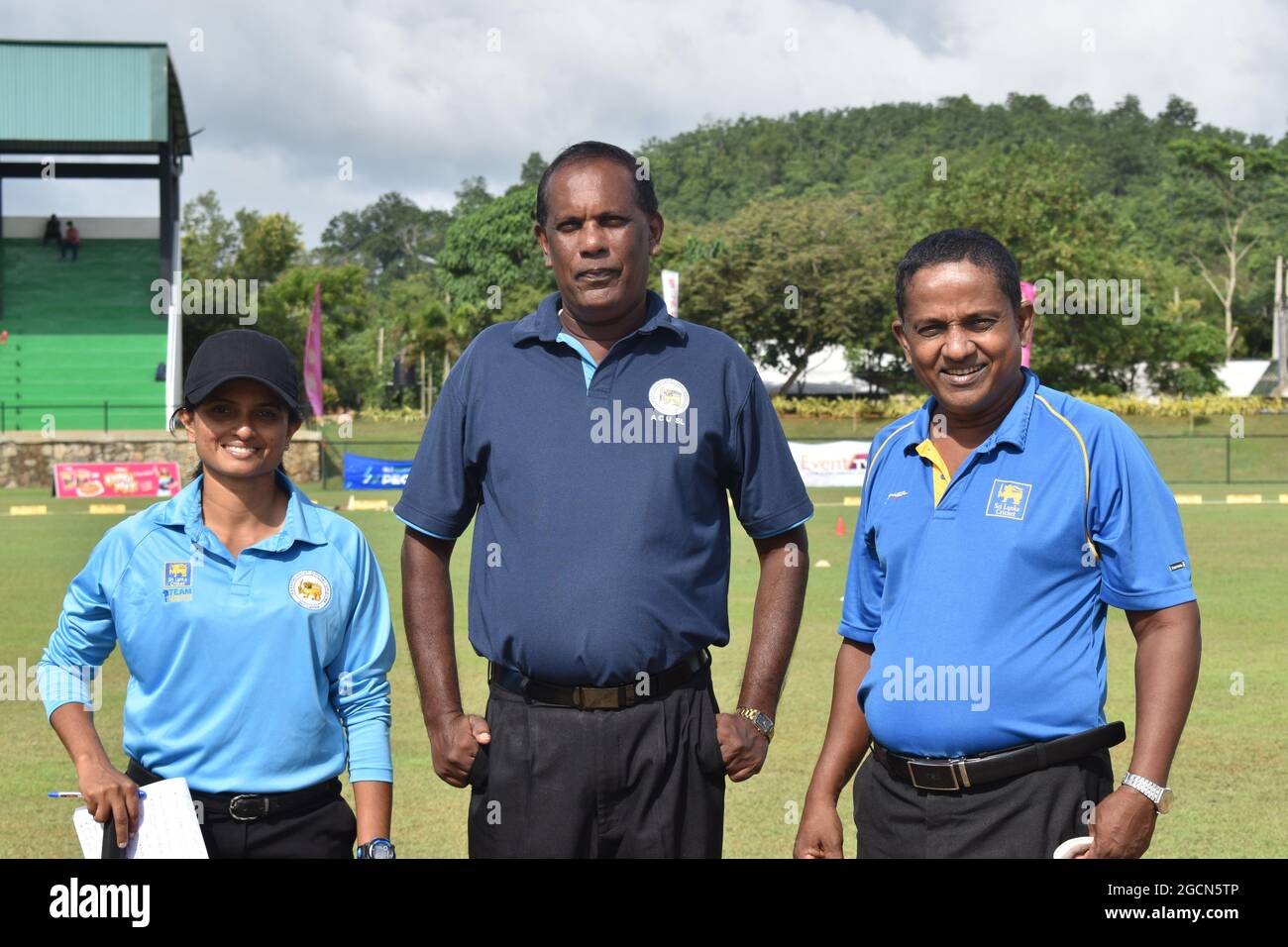 Sri Lanka female cricket umpire with male umpires at a cricket match at the Army Ordinance cricket grounds, Dombagoda. Females who have been involved with cricket as players are taking up umpiring and scoring to be involved with the game. Sri Lanka. Stock Photo
