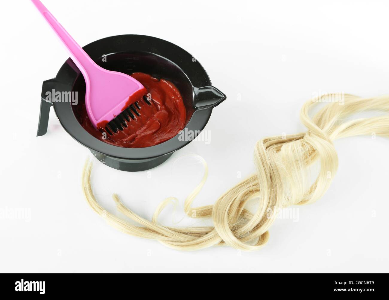 Bowl with hair dye and brush for hair coloring, isolated on white Stock
