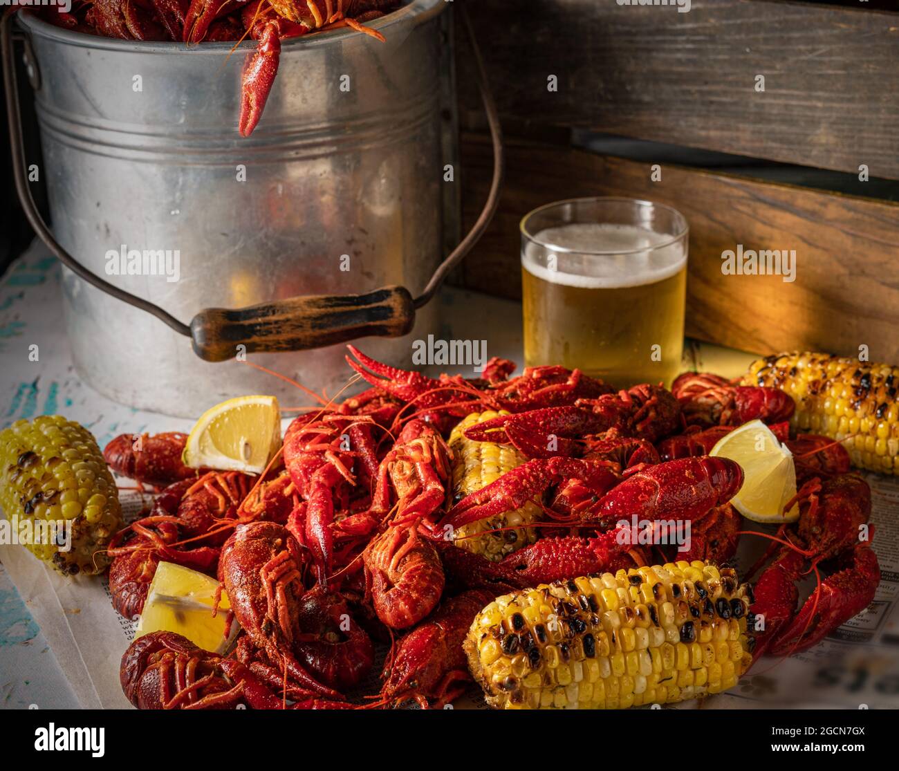 Steamed crawfish with grilled corn and beer. Stock Photo