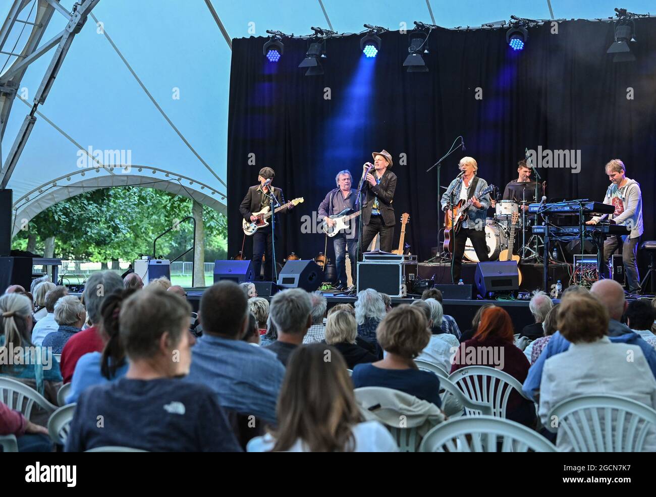 Neuhardenberg, Germany. 08th Aug, 2021. Alexander Scheer (3rd from left), actor, musician, singer and Andreas Dresen (3rd from right), director, musician, singer play Gundermann songs on a stage in the park of Neuhardenberg Castle to kick off the summer program. The programme of the open-air event series 'Into the open air!' runs until 05.09.2021. Many different concerts, readings and talks will take place under the large tent roof in the castle park. Credit: Patrick Pleul/dpa-Zentralbild/ZB/dpa/Alamy Live News Stock Photo