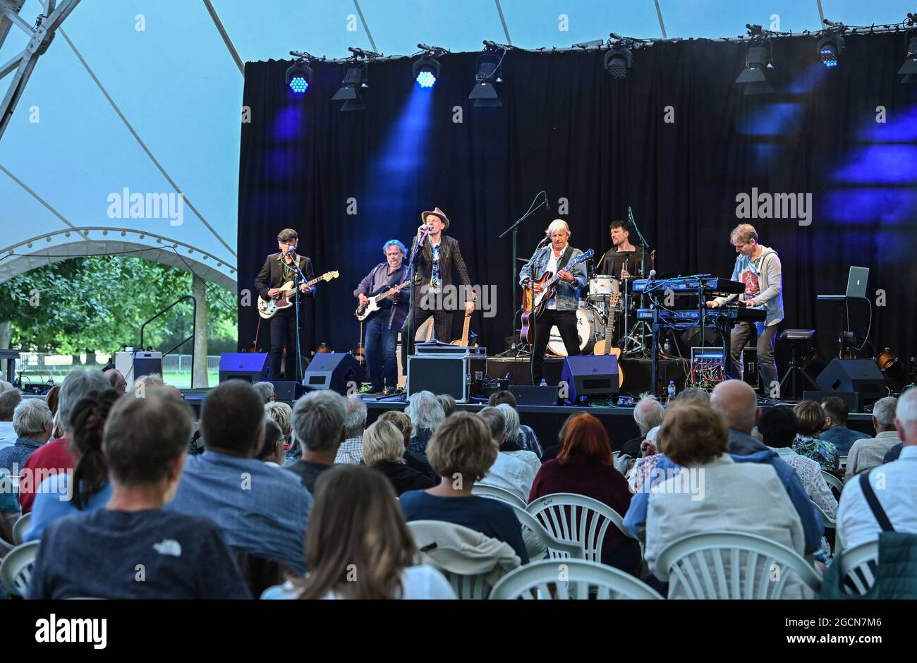 Neuhardenberg, Germany. 08th Aug, 2021. Alexander Scheer (3rd from left), actor, musician, singer and Andreas Dresen (3rd from right), director, musician, singer play Gundermann songs on a stage in the park of Neuhardenberg Castle to kick off the summer program. The programme of the open-air event series 'Into the open air!' runs until 05.09.2021. Many different concerts, readings and talks will take place under the large tent roof in the castle park. Credit: Patrick Pleul/dpa-Zentralbild/ZB/dpa/Alamy Live News Stock Photo