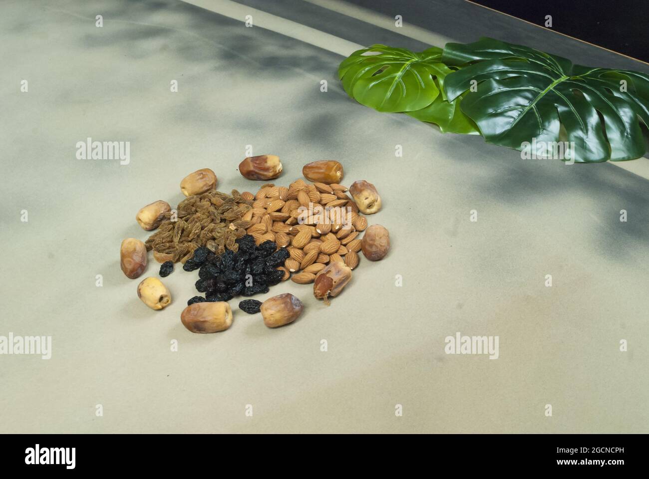 mix dry fruits nuts around dates isolated almonds black and brown raisins(kishmish) Stock Photo