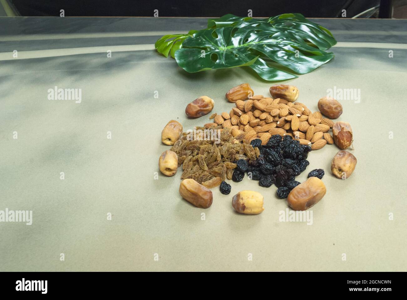 mix dry fruits nuts around dates isolated almonds black and brown raisins(kishmish) Stock Photo