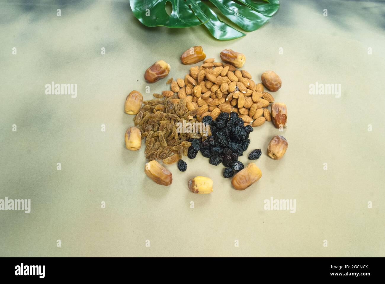 mix dry fruits nuts around dates isolated almonds black and brown raisins(kishmish) Stock Photo