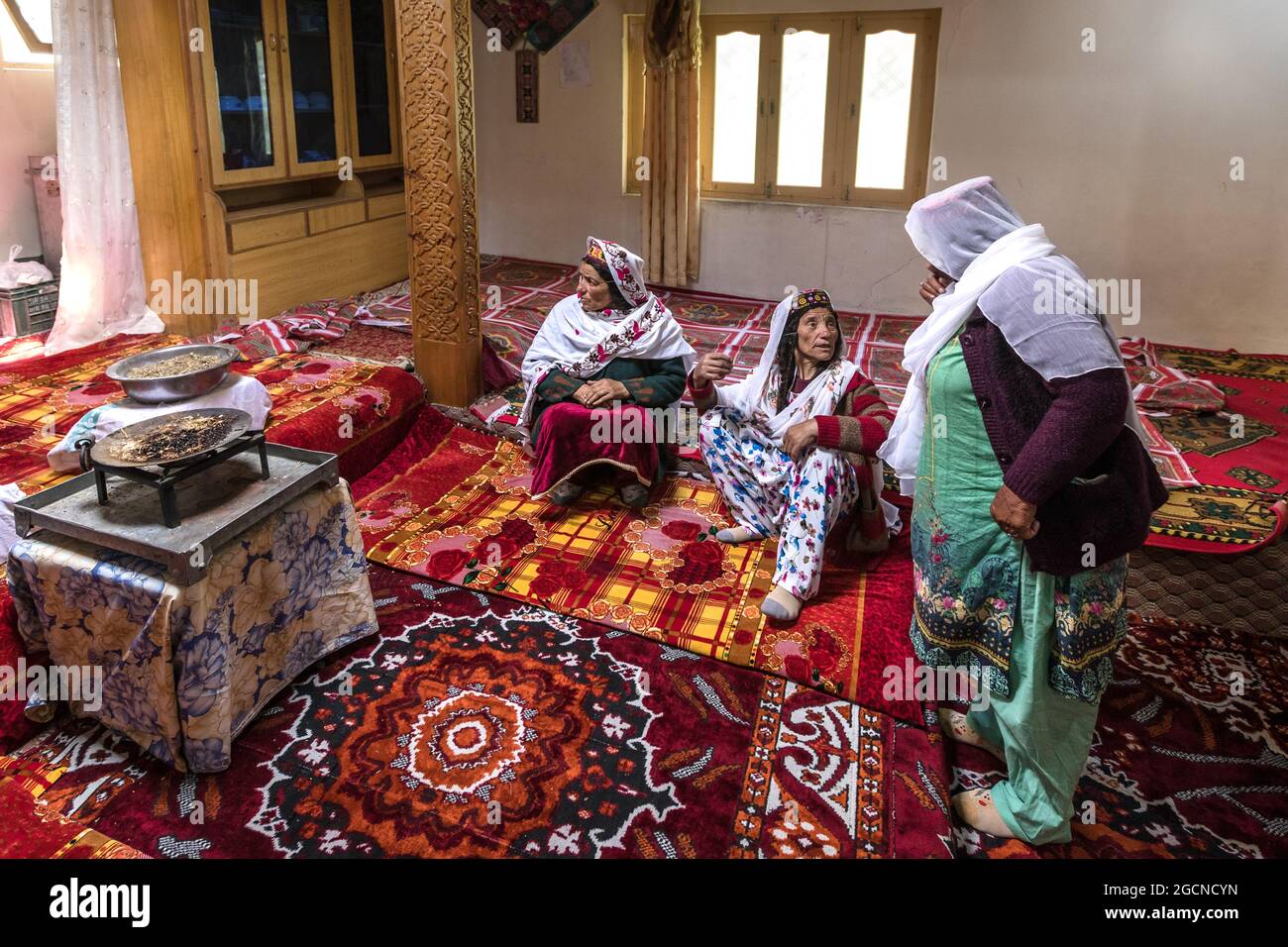 Gilgit-Baltistan, Pakistan - June 2021: old waken women in traditional house  Stock Photo