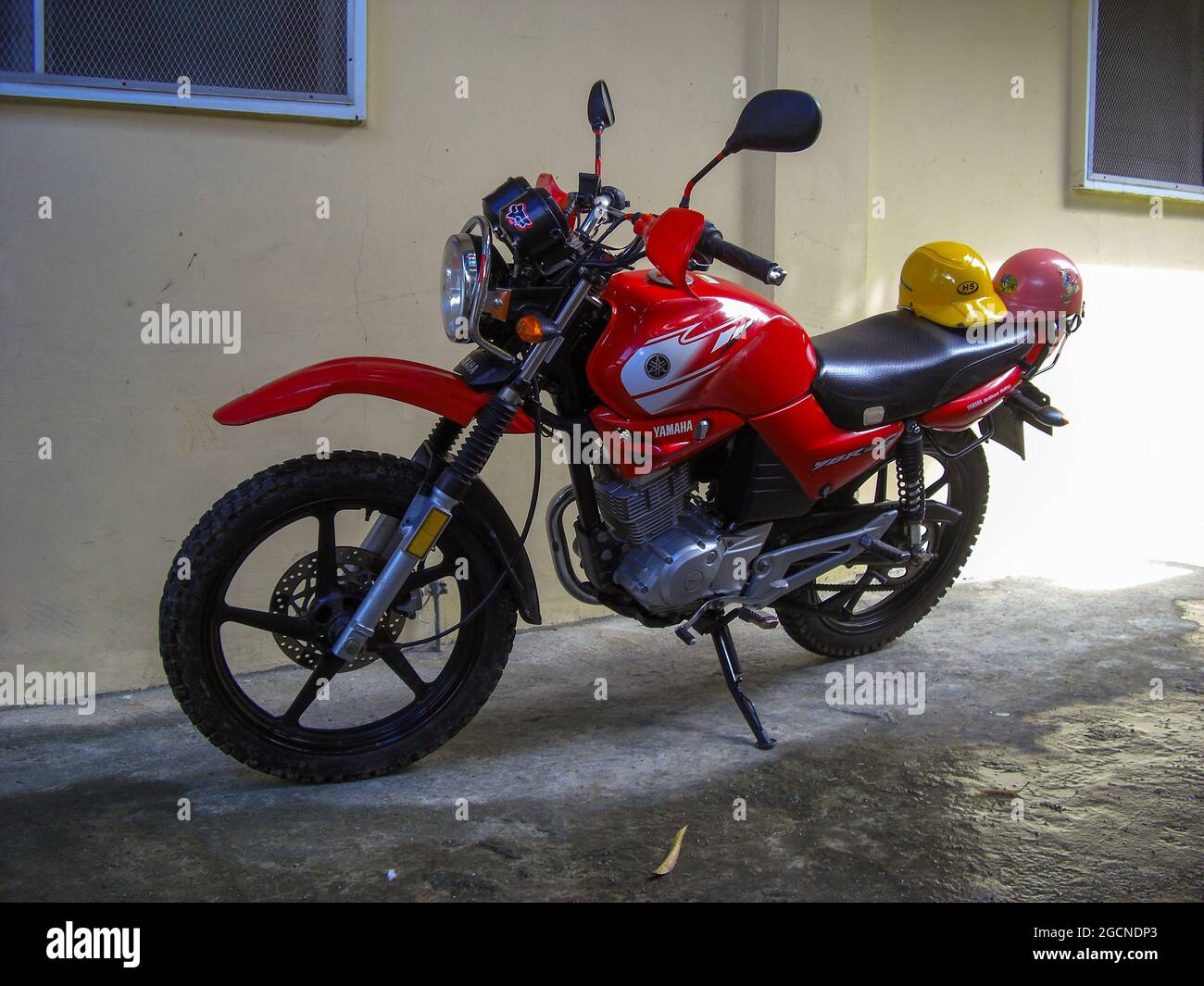 Red Yamaha YRB-125 parking next to a wall in Puerto Galera at the Philippines 16.11.2012 Stock Photo