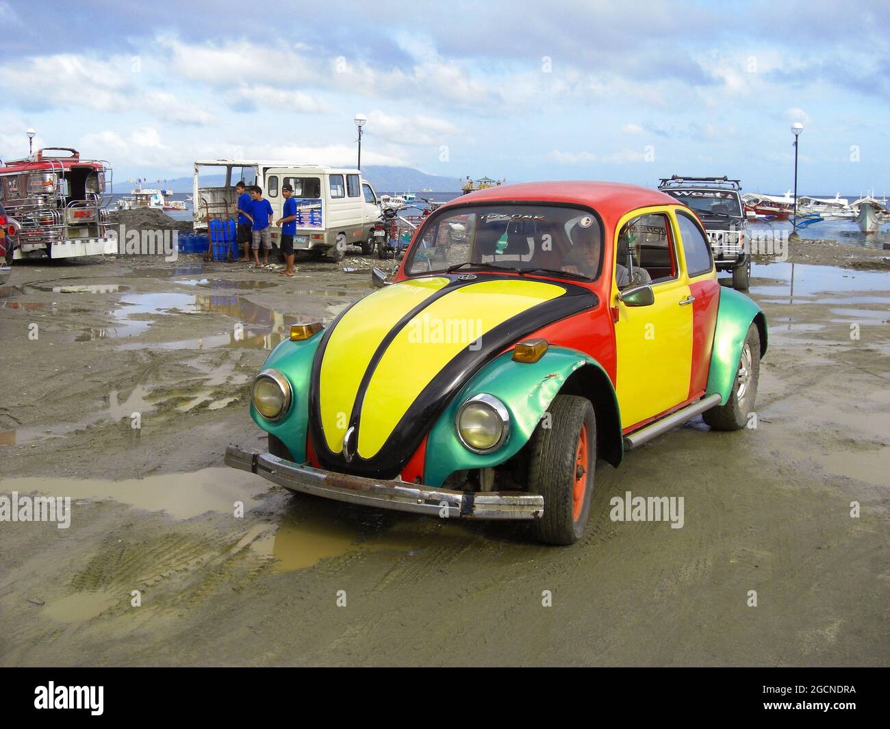 Old and colorful painted VW Kafer at the harbor in Puerto Galera on the Philippines 13.12.2012 Stock Photo
