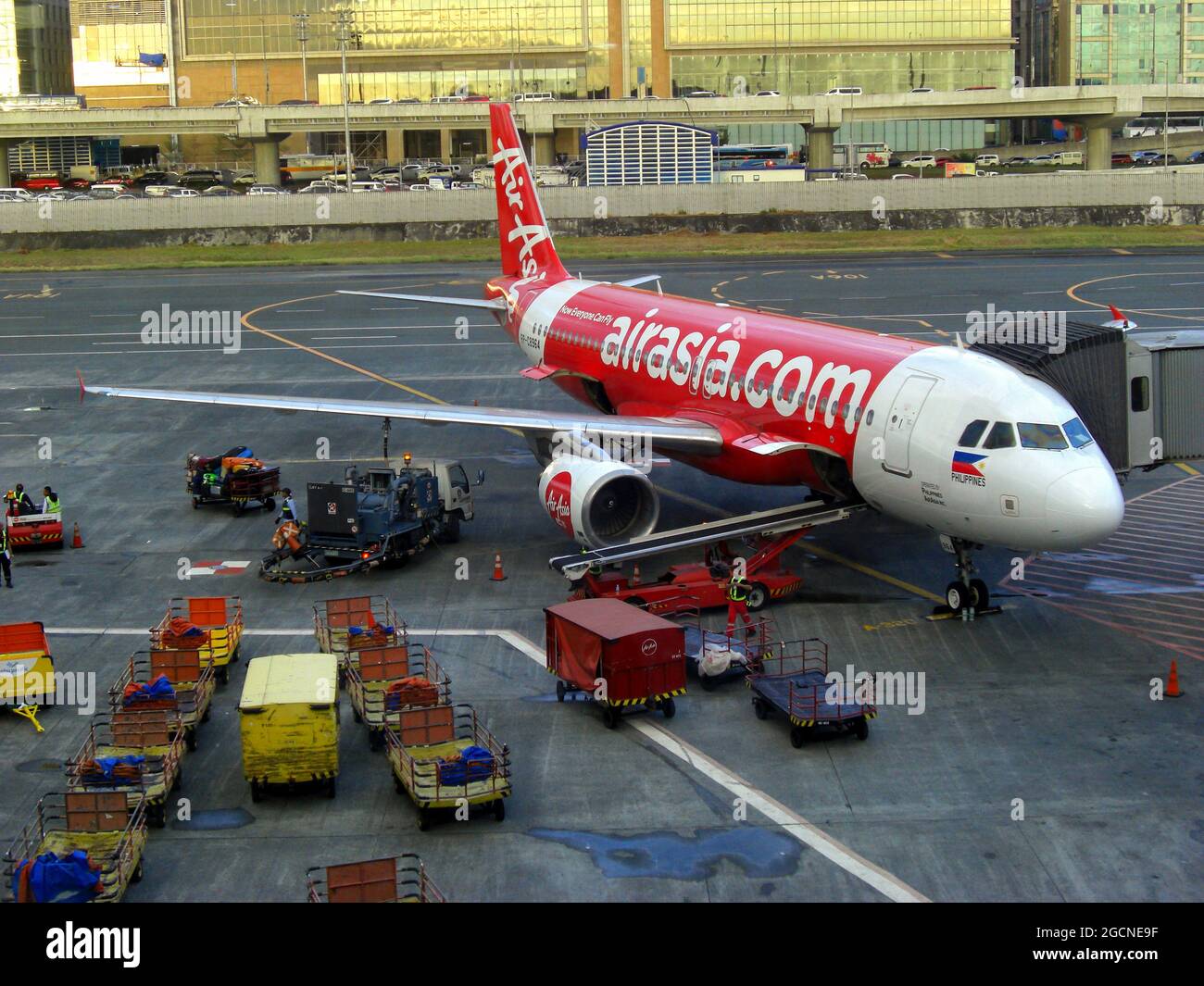Air Asia Airbus A320216 is parking at the gate at the international
