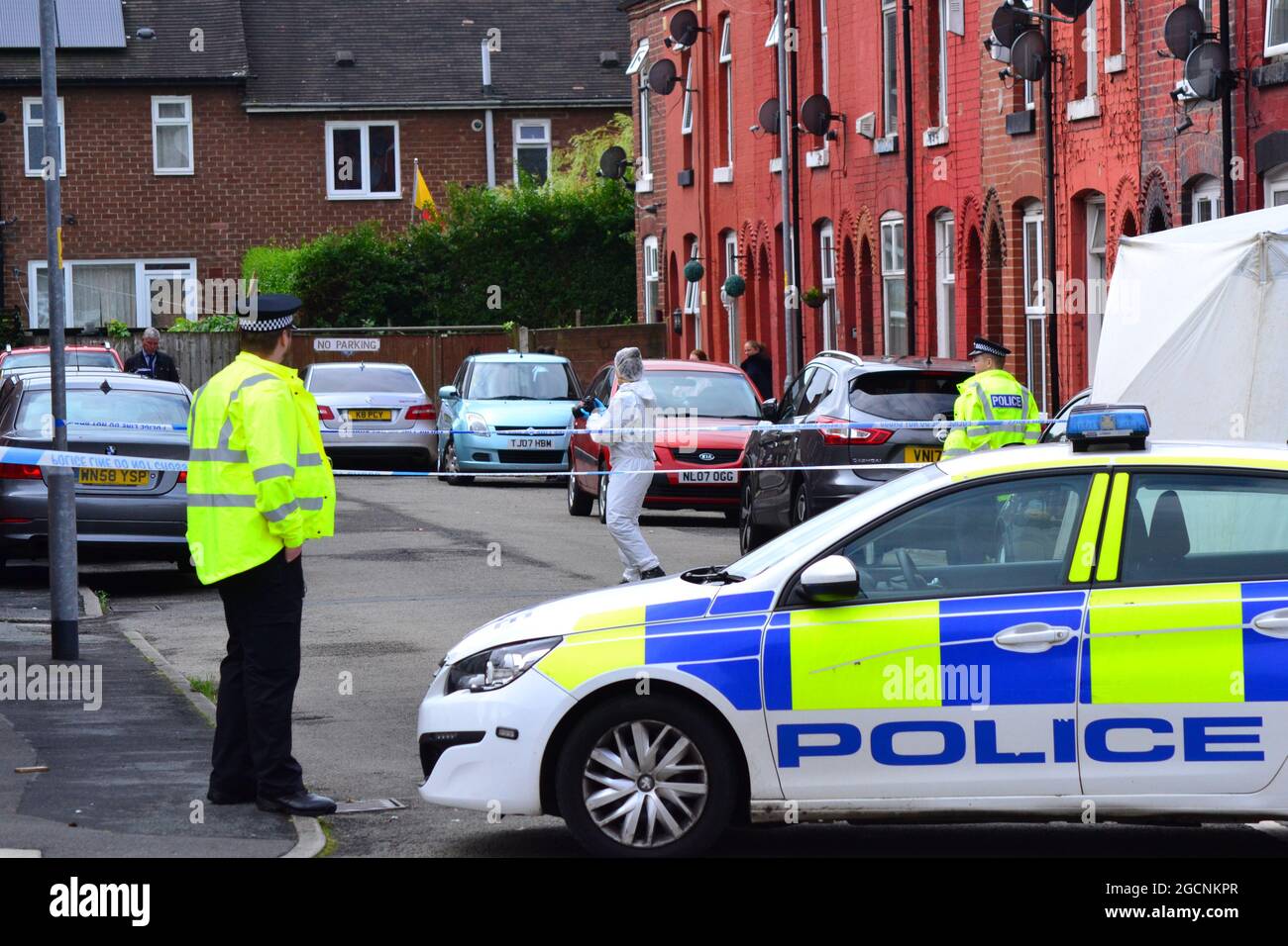 Police cordon Friendship Ave, Manchester, UK. Greater Manchester Police statement: 'At around 10.20pm last night (Sunday 8 August 2021) police were called to Woodland Road, Manchester to reports of an attempted murder. Officers attended and established that a 63-year-old man had been struck by a Citroen C5 car and sustained serious injuries. The car used in the incident has since been recovered by officers and the man has been taken to hospital where he remains for treatment. Two men, aged 28 and 25, have been arrested on suspicion of attempted murder. They remain in custody for questioning.' Stock Photo