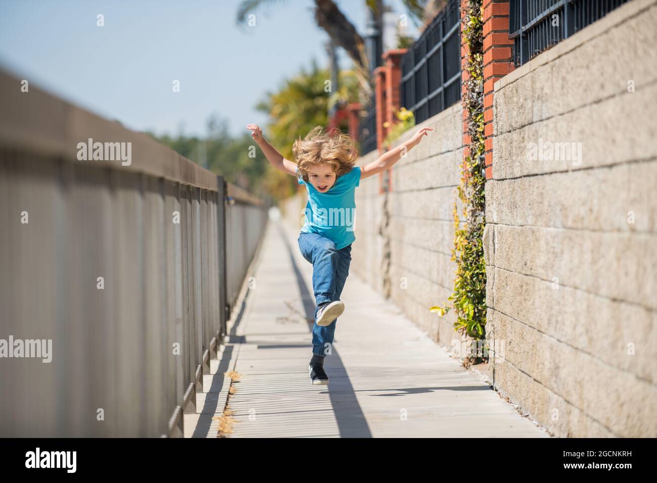 When living an active life be happy and energetic. Energetic kid run on promenade. Fun childhood Stock Photo