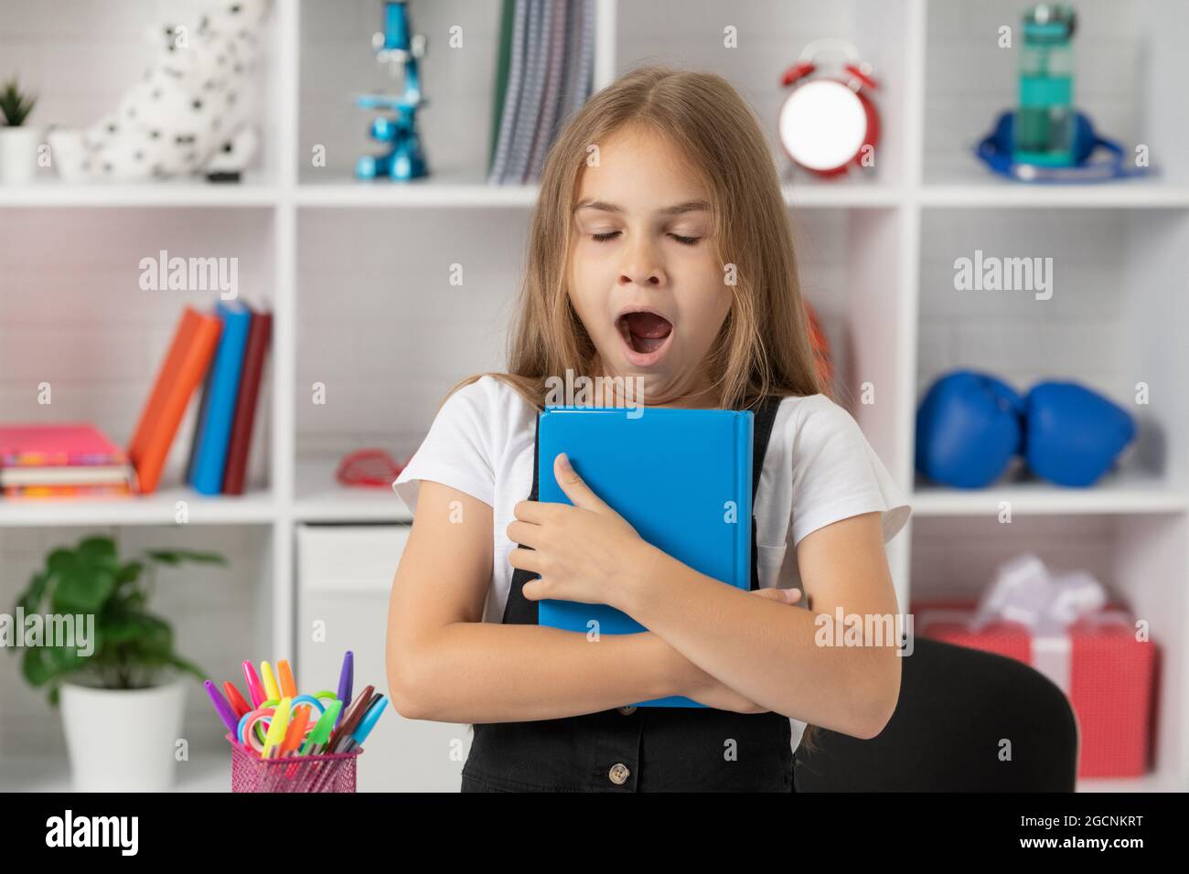 lesson for child holding copybook. schoolgirl hold notebook. back to school. childhood education. Stock Photo