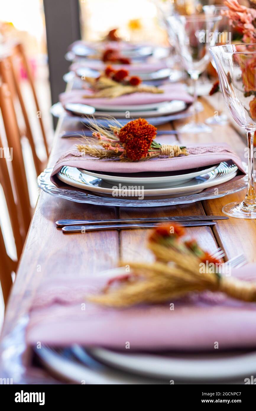 Table reserved for guests, decorated for event or wedding party. Table set for wedding party. Stock Photo