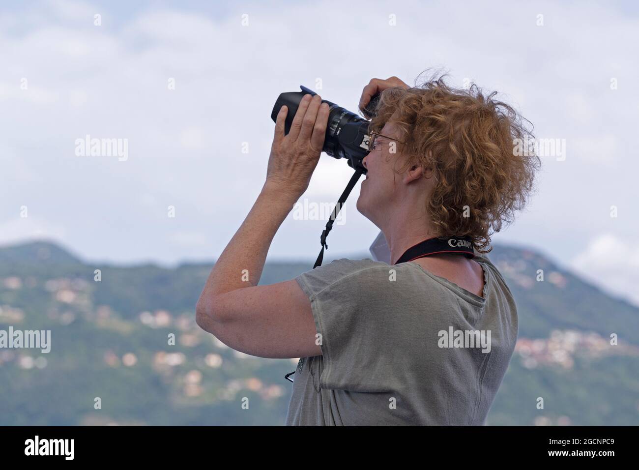 woman taking photos, Lake Maggiore, Piedmont, Italy Stock Photo