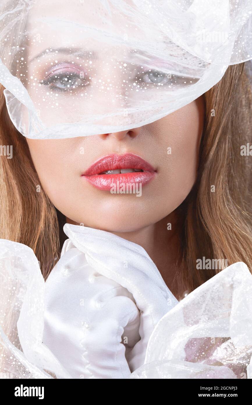 Portrait of young beautiful woman with white veil and little hat Stock Photo