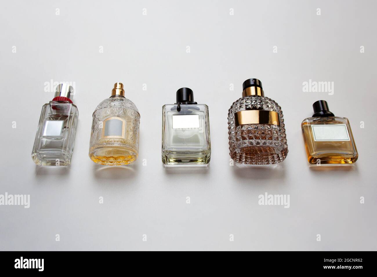 Five glass perfume bottles isolated on white background Stock Photo