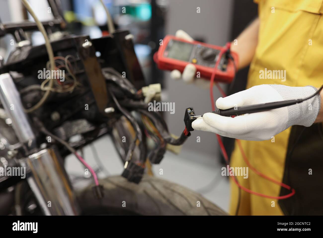Electronics repair service master using multimeter tester to determine the problem part Stock Photo
