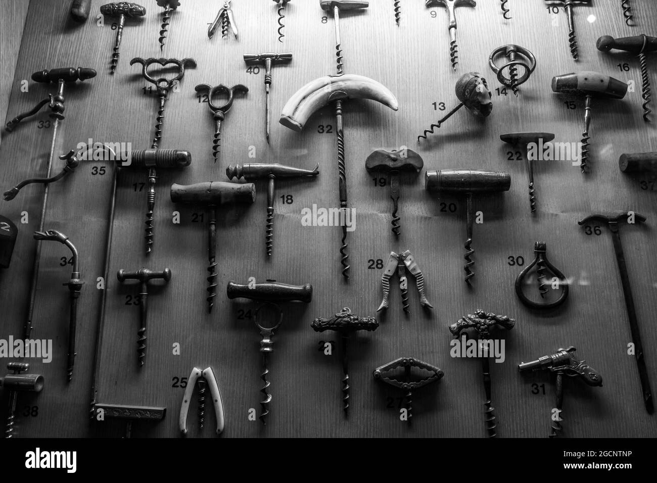 PARIS, FRANCE - Aug 06, 2021: Old Wine bottle corkscrews in a museum. Antique objects. Stock Photo