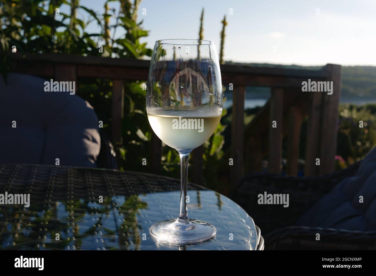 Glass of wine on a table at Bondy's Cafe, Old Town, St Mary's island, Isles of Scilly, Cornwall, England, UK, July 2021 Stock Photo