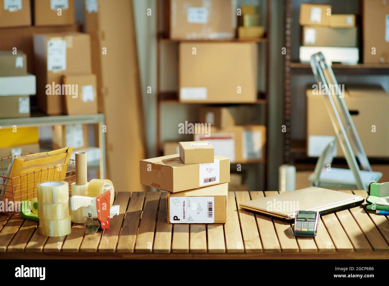 Delivery business. desk with laptop, parcels, packing tape dispenser