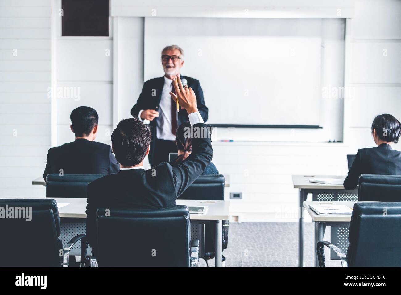 Senior leader speaker speaks to public people audience in training