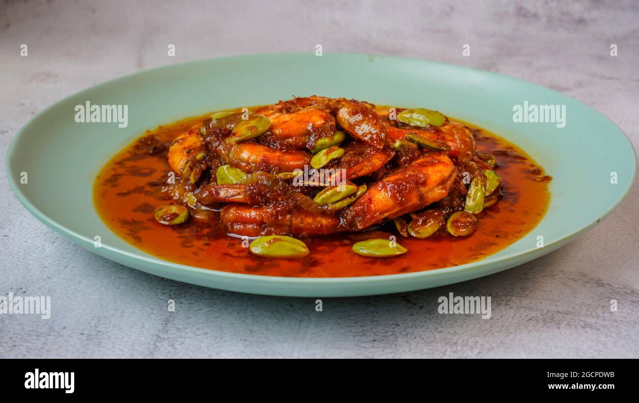 Delicious shrimp spicy dish with stinky beans known in Malaysia as Sambal Udang Petai. Stock Photo