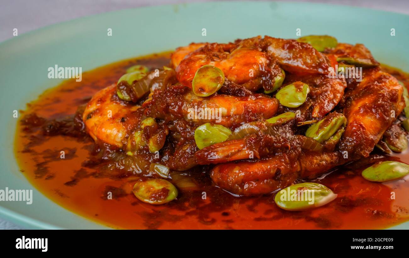 Delicious shrimp spicy dish with stinky beans known in Malaysia as Sambal Udang Petai. Stock Photo